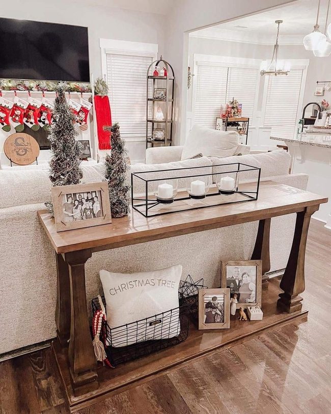 Natural Wood Console With Evergreens And Red Accents