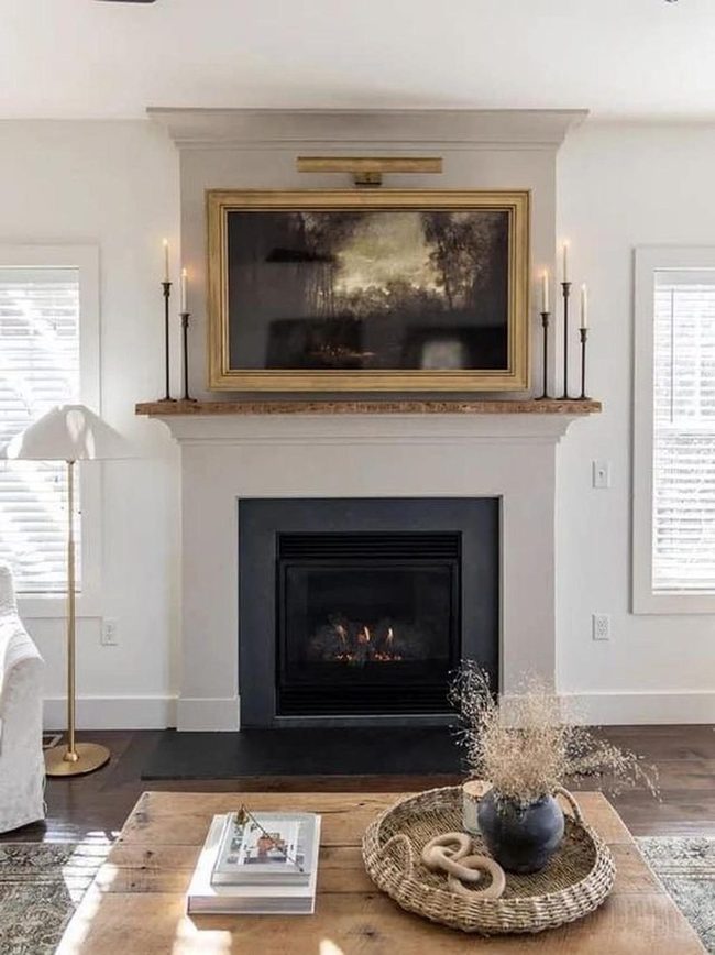 Stone Fireplace With Gold-Framed Art
