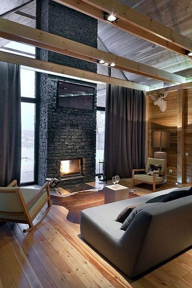 Dark Stone Fireplace And Wooden Beams
