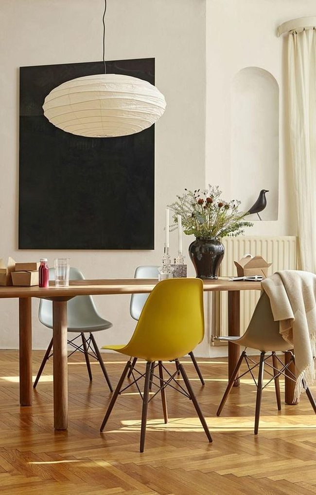 Black Art Above Yellow Chairs
