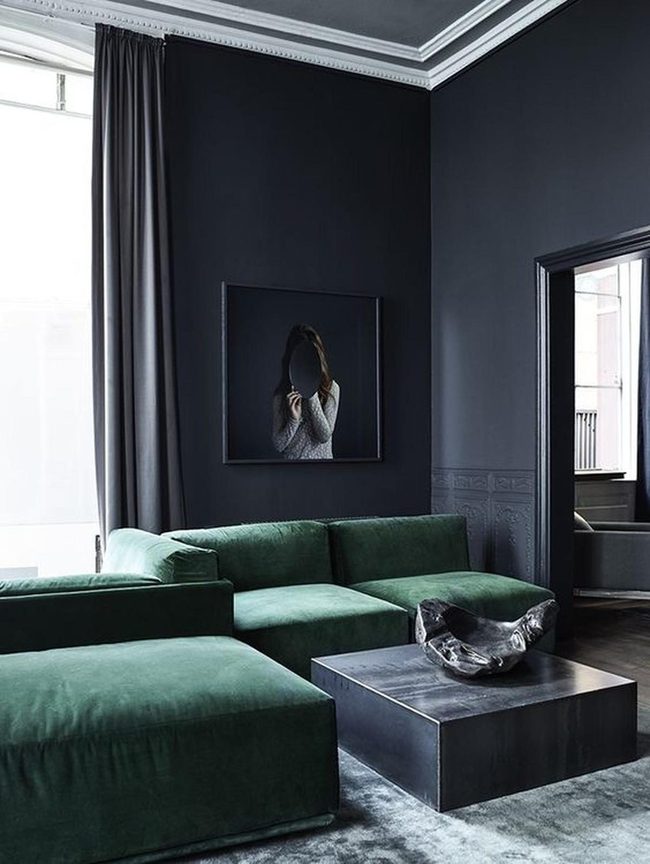 Green Couches Against Dark Walls