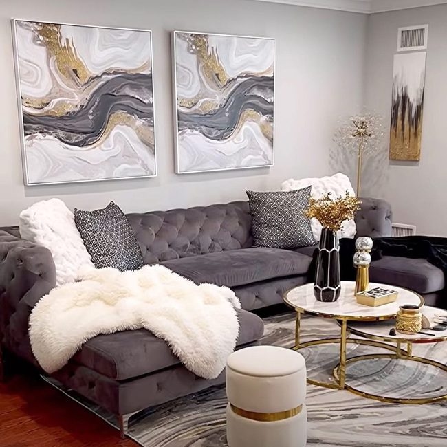 Gray Sofa With Gold Swirling Art