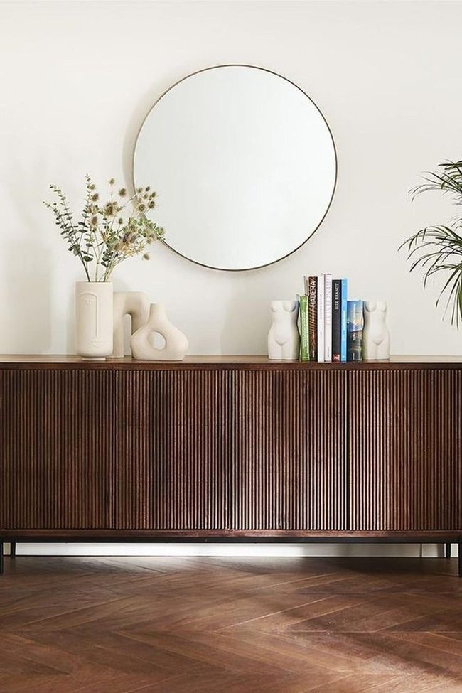 Round Mirror Reflects Natural Wood Warmth