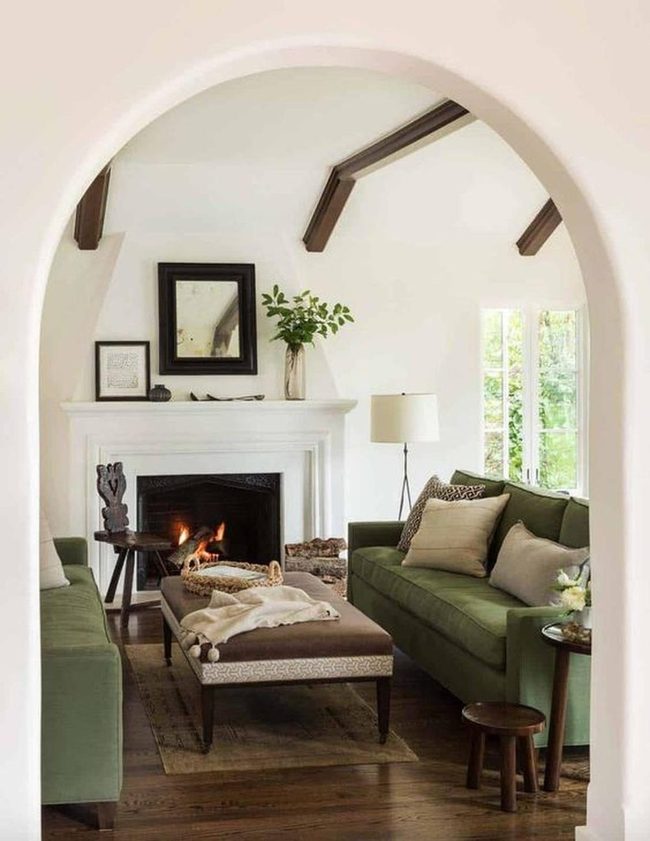 Green Couches White Walls Fireplace
