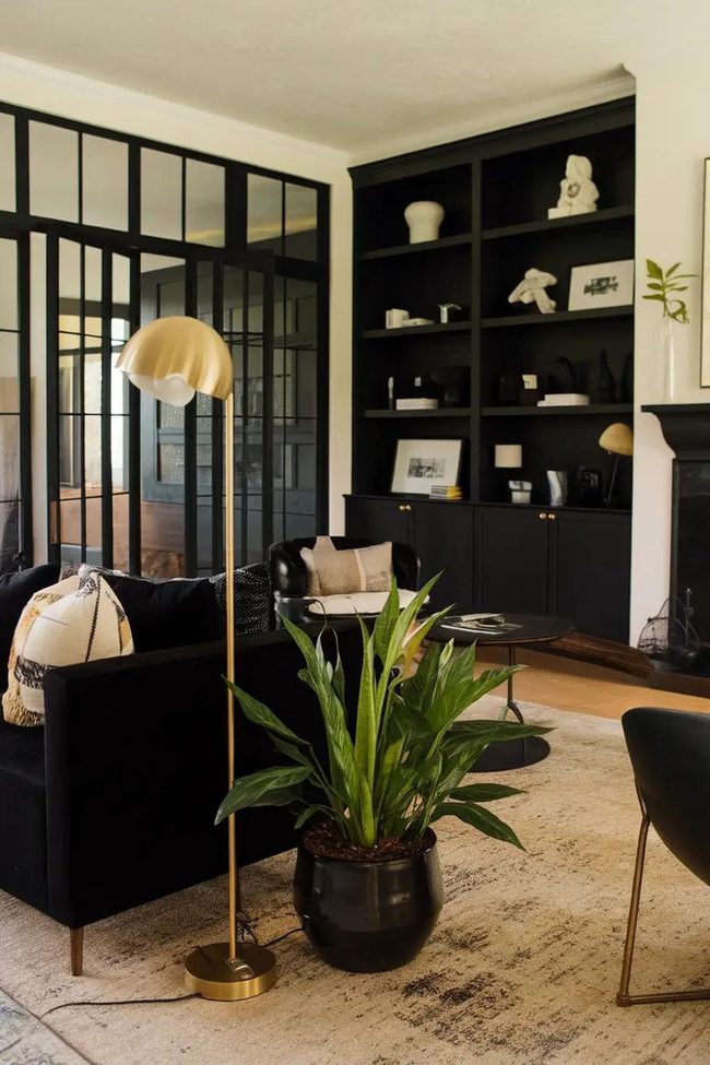 Black Couch Anchors Minimalist Space