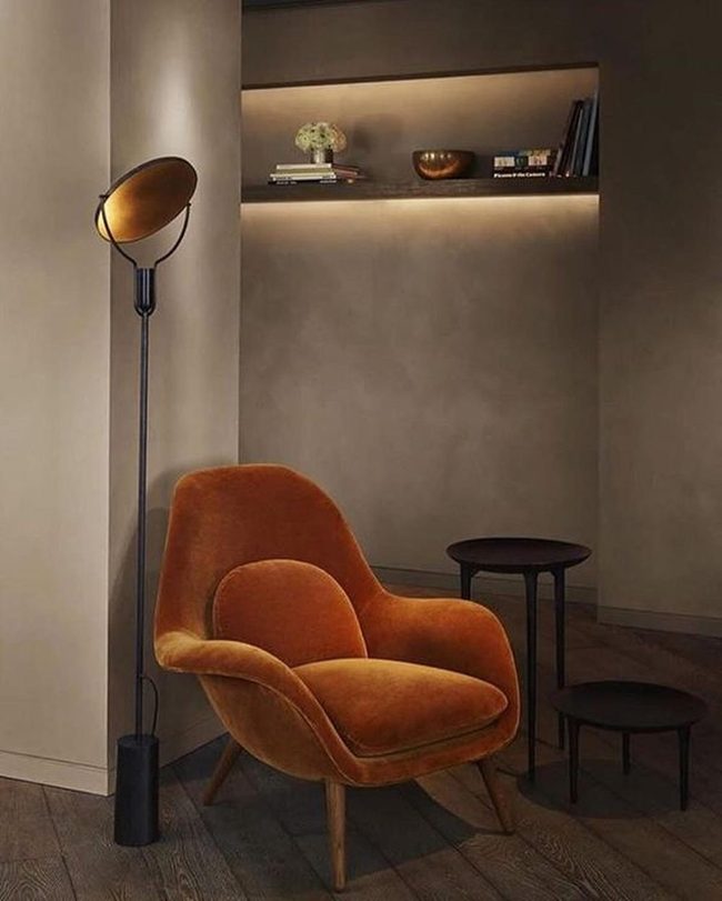 Orange Curved Chair Anchors Warm Brown Interior