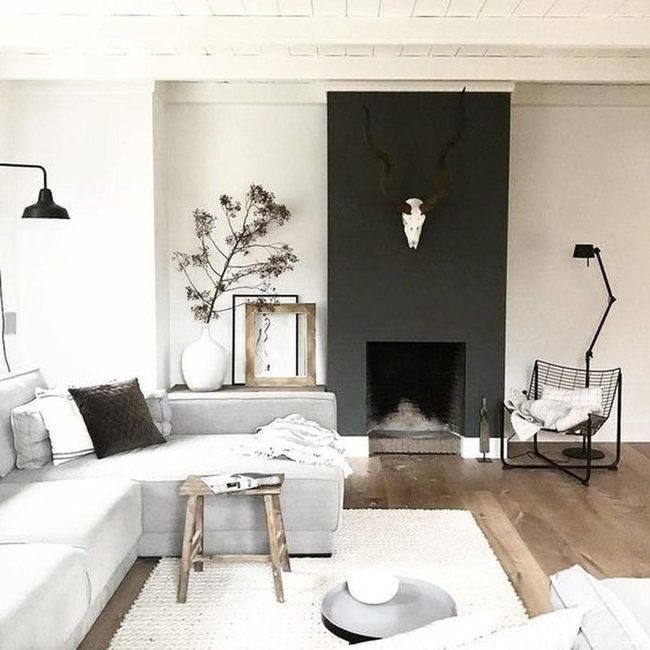 Dark Fireplace Anchors Light Gray Room