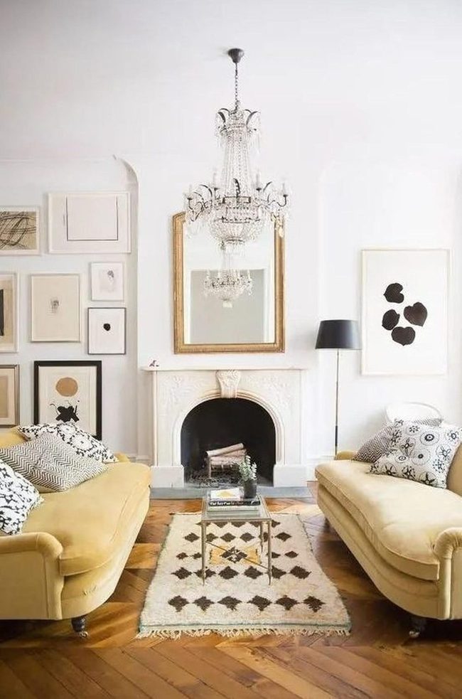 Yellow Couches Face Ornate White Fireplace