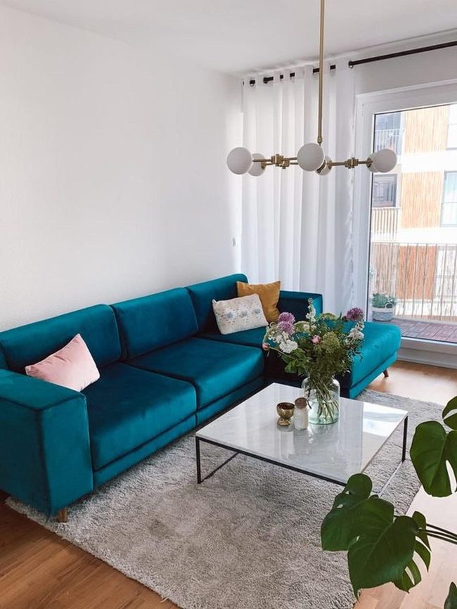Teal Couch, White Walls, Marble
