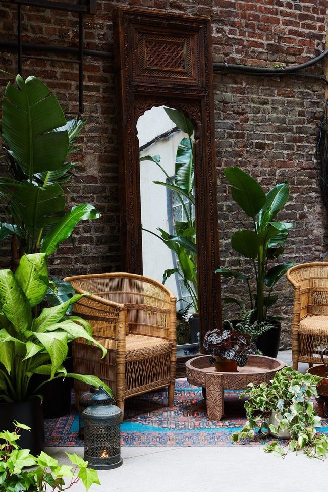 Hand-Carved Mirror Against Brick