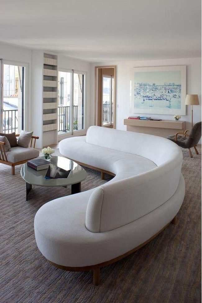 Sunlit Living Space With Curved White Sofas