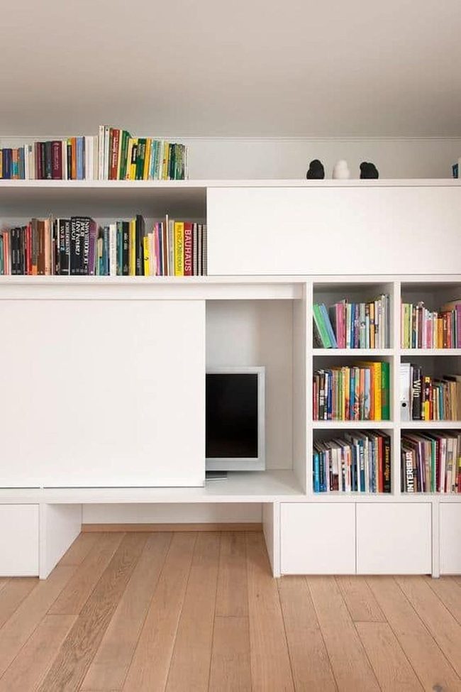 White Shelves, Colorful Books, Hidden Tv