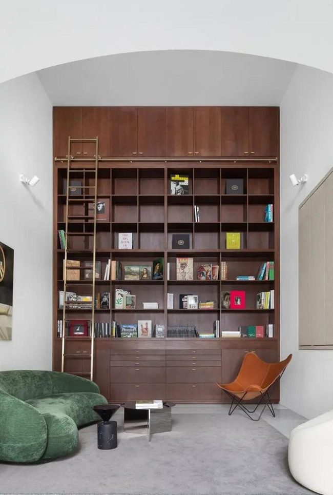 Floor-To-Ceiling Wooden Shelves Orange Accent