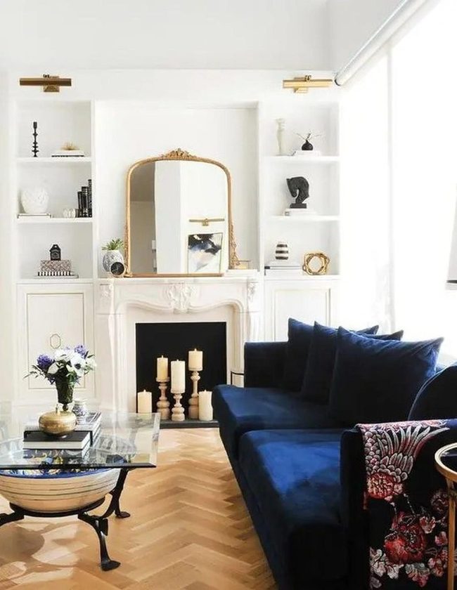 Deep Blue Velvet Meets Carved Fireplace