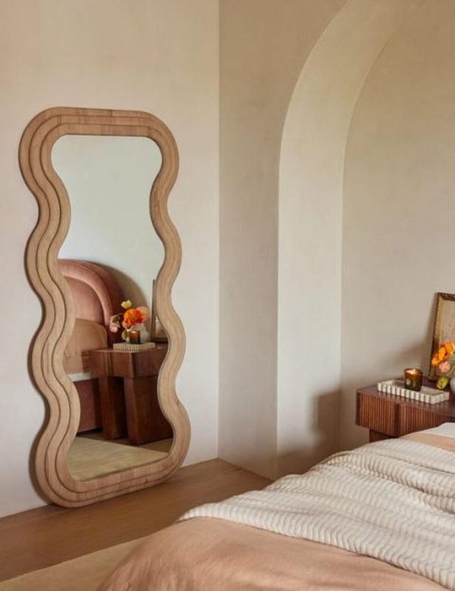 Wavy Mirror Frames Sunlit Bedroom