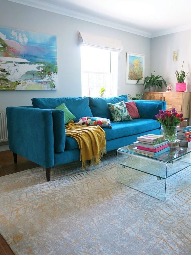 Teal Sofa Anchors Colorful Room
