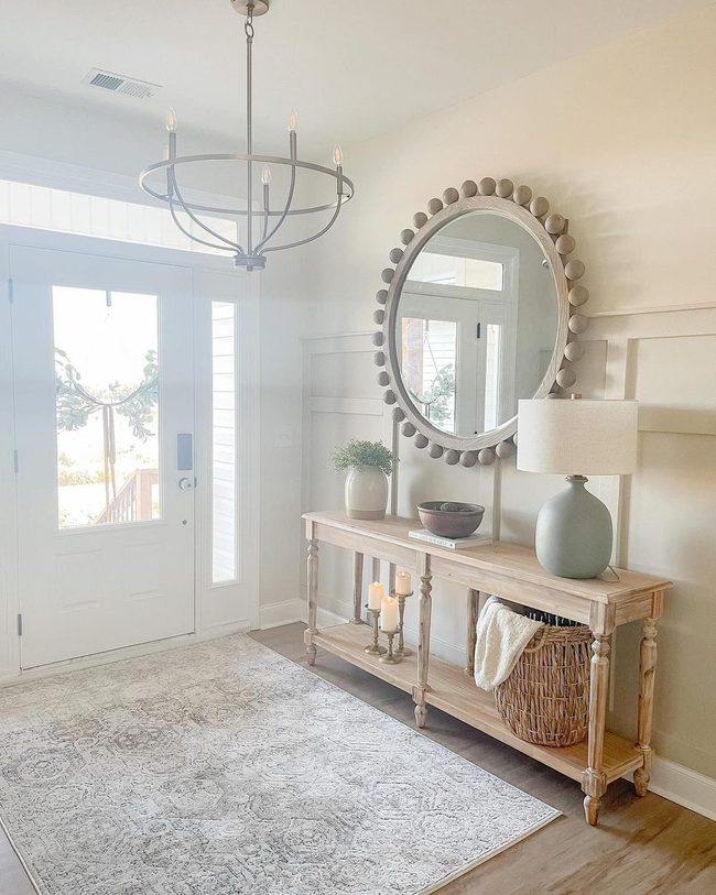 Circular Mirror Brightens Natural Wood Entry