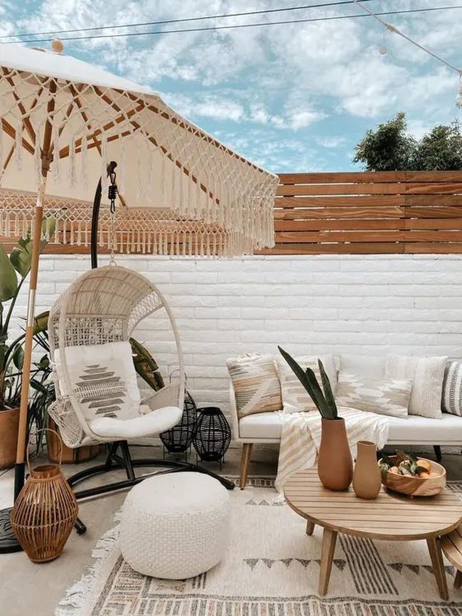 White Hanging Chairs With Fringed Umbrellas
