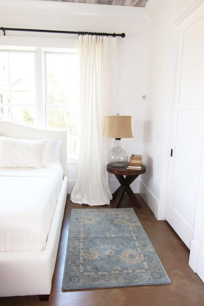 Sunlit White Bedroom With Wood Beams