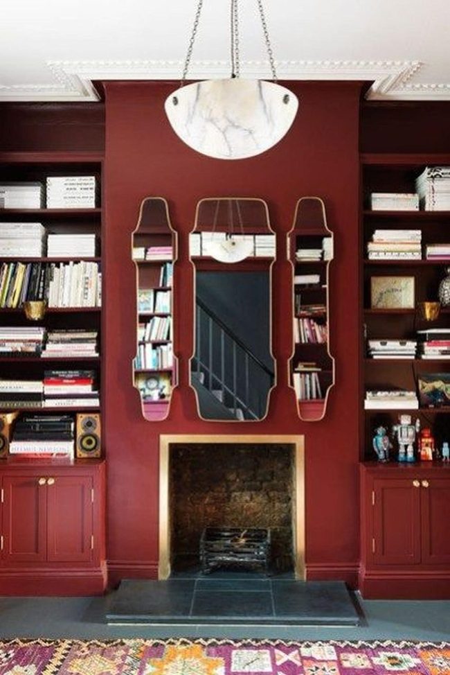 Deep Red Walls With Gold-Trimmed Mirrors
