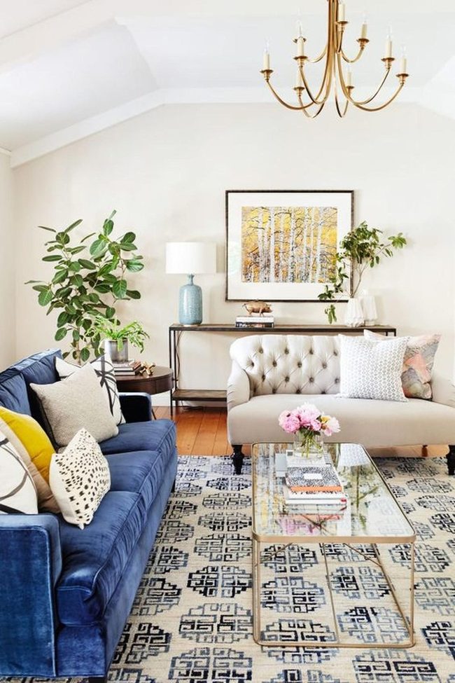 Golden Chandelier Meets Deep Blue Sofas