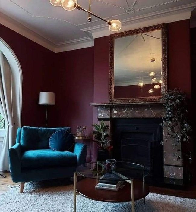 Deep Red Walls With Blue Reading Chair