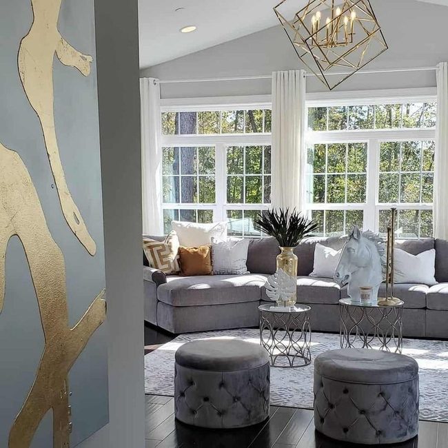 Gold Geometric Pendants Above Gray Tufted