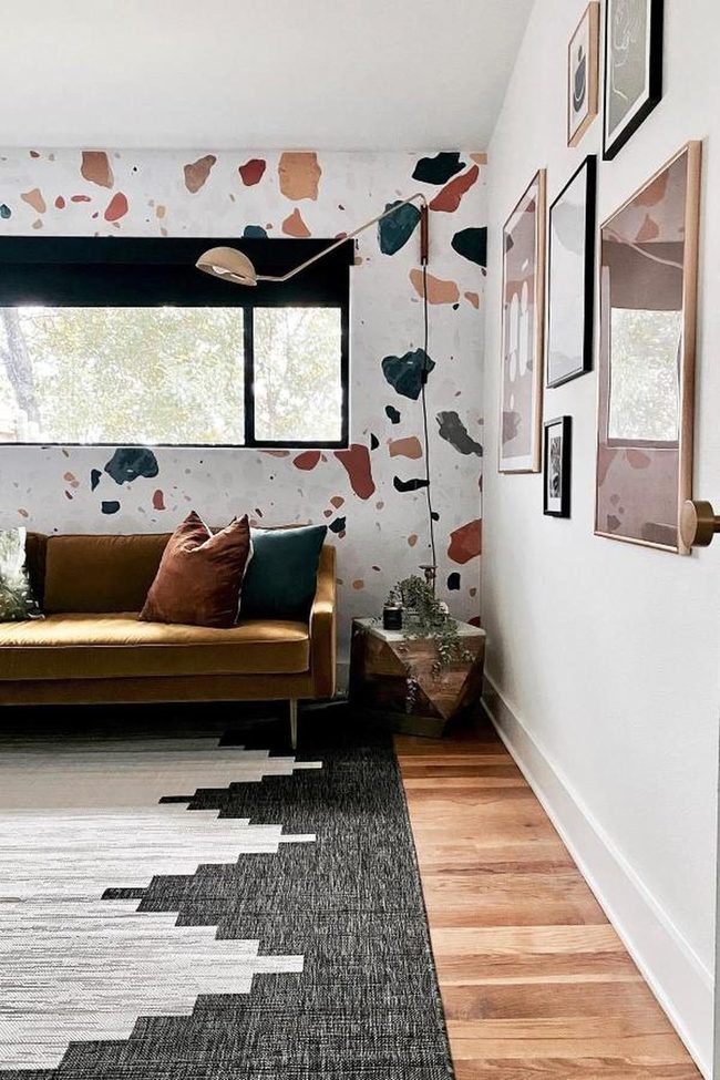 Golden Sofa With Terrazzo Wall Statement