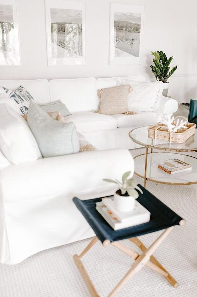 White Sofas With Neutral Pillows And Plants
