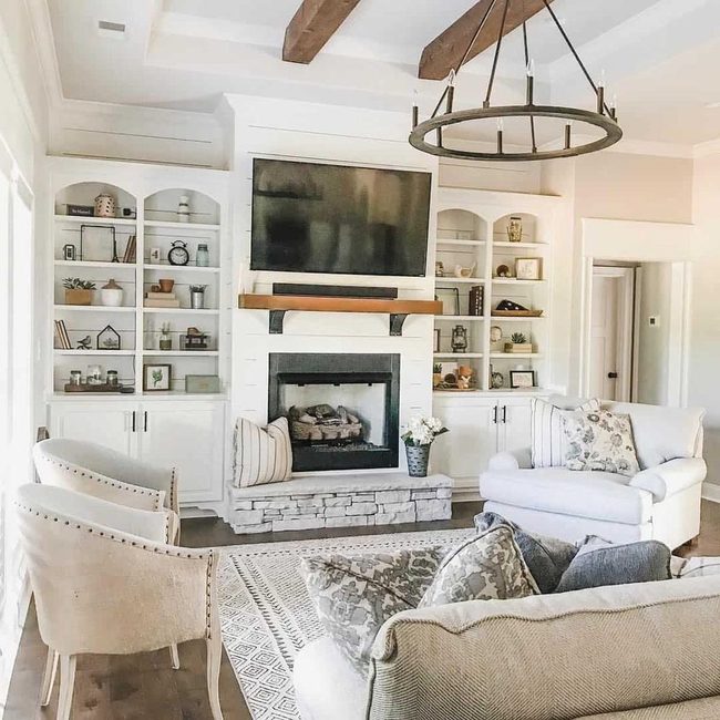 Black Wheel Chandeliers Over Wood Beams