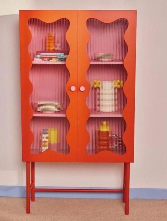 Orange Cabinet With Pink Interior Shelving