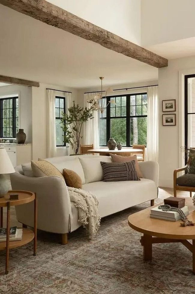 Exposed Wood Beams Meet Cream Sofas