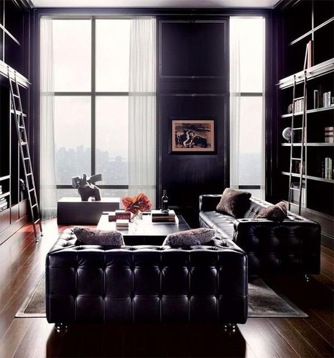 Sunlit Library With Dark Leather Sofas