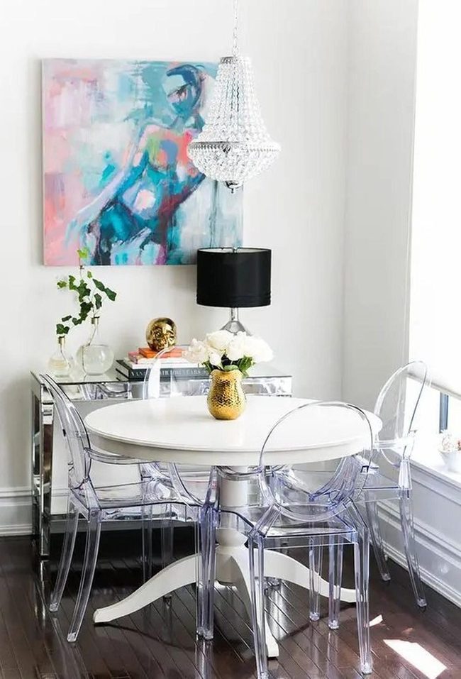 Chandeliers And Clear Chairs Define Modern Dining