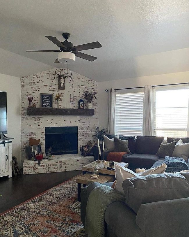 Gray Couches With Towering Stone Fireplace