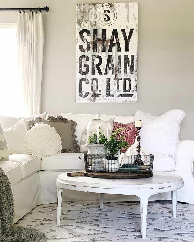 Weathered Wood Sign Above White Seating