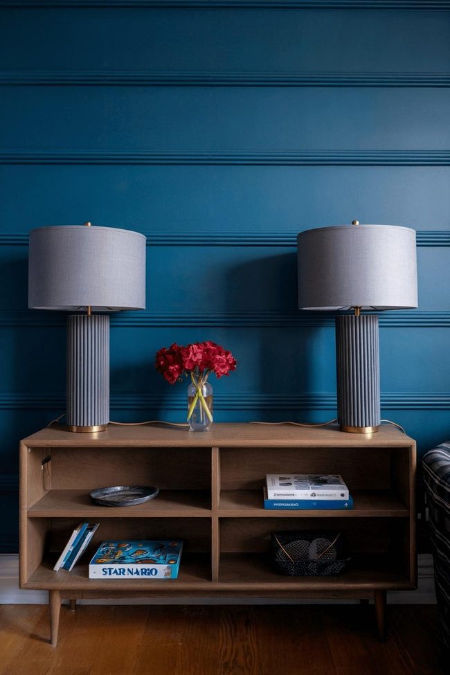 Deep Blue Walls With Earthy Wood Console