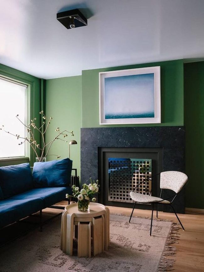 Dark Stone Fireplace Meets Green Walls