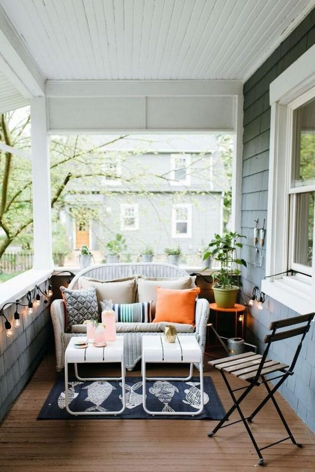 White Wicker Porch With Fish-Patterned Rug