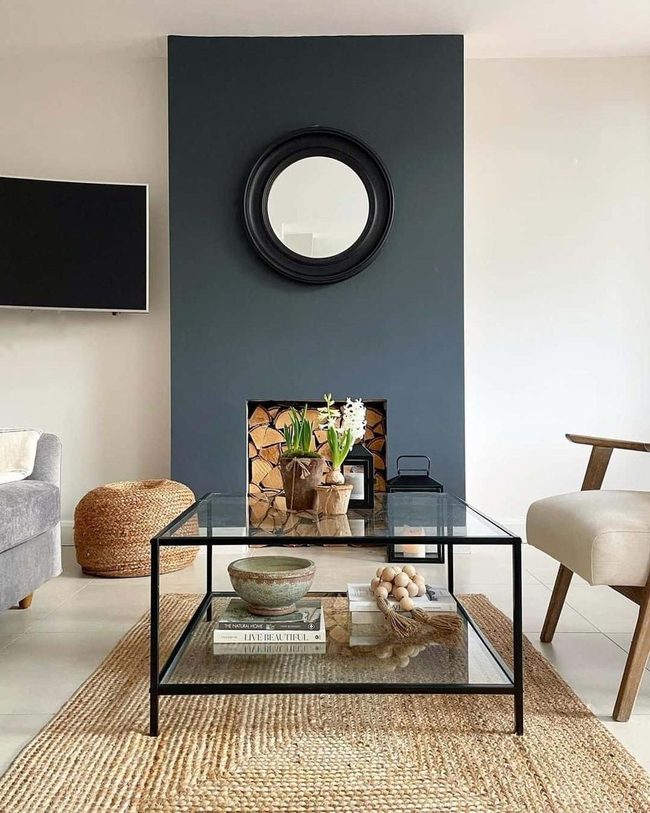 Gray Stone Fireplace With Circular Mirror