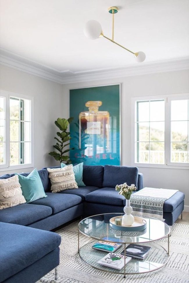 Blue Sectional With Perfume Bottle Art
