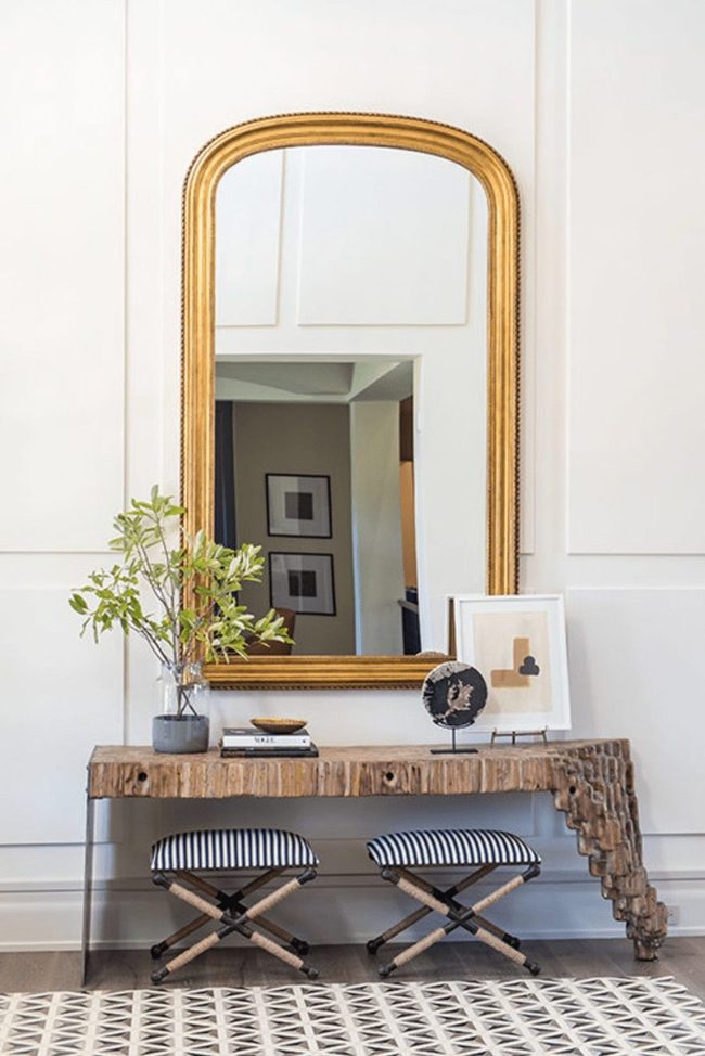 Curved Wood Entry With Golden Mirror Statement
