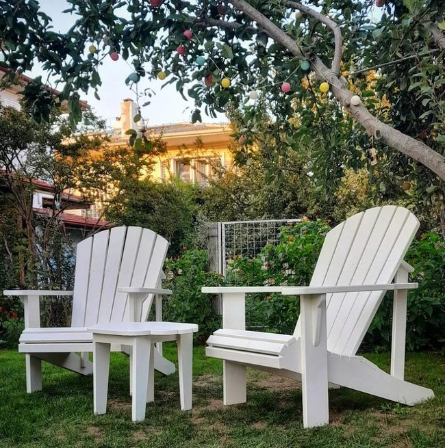 White Wooden Chairs In Emerald Garden