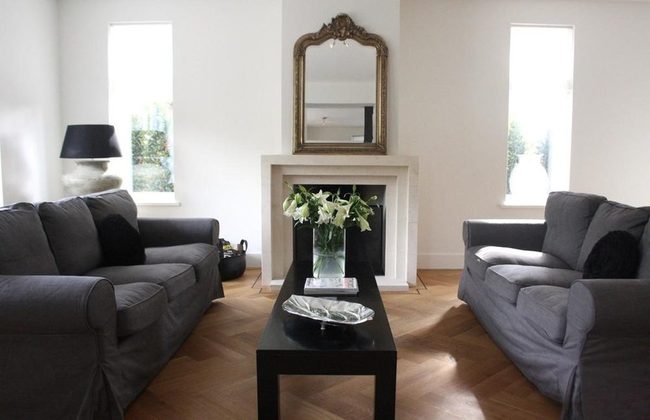 Gray Sofas, Black Accents, Infinite Light