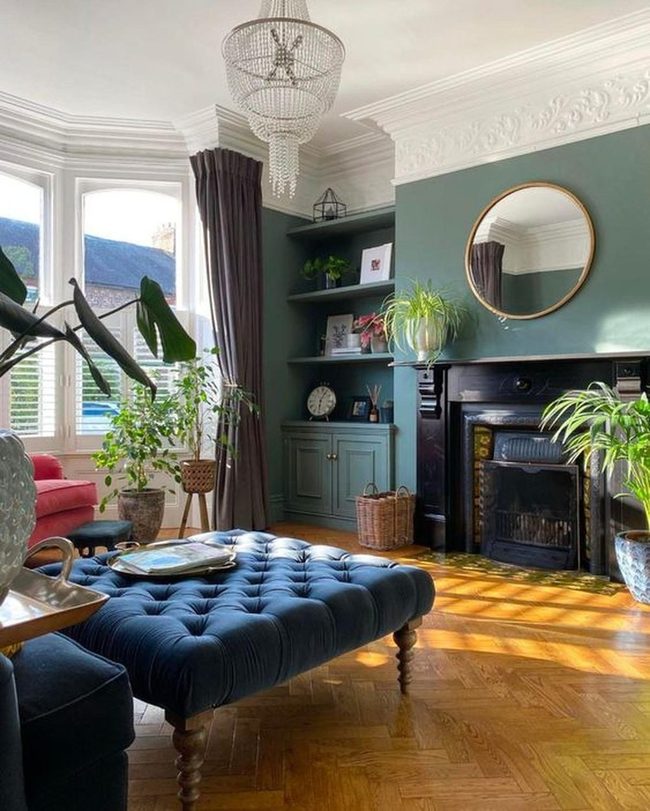 Green Walls With Striking Blue Ottoman