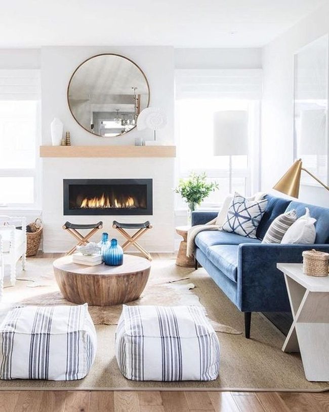 Round Mirror Anchors Warm Fireplace Space