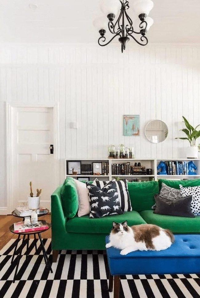 Green Couch, White Paneling, Black Chandeliers