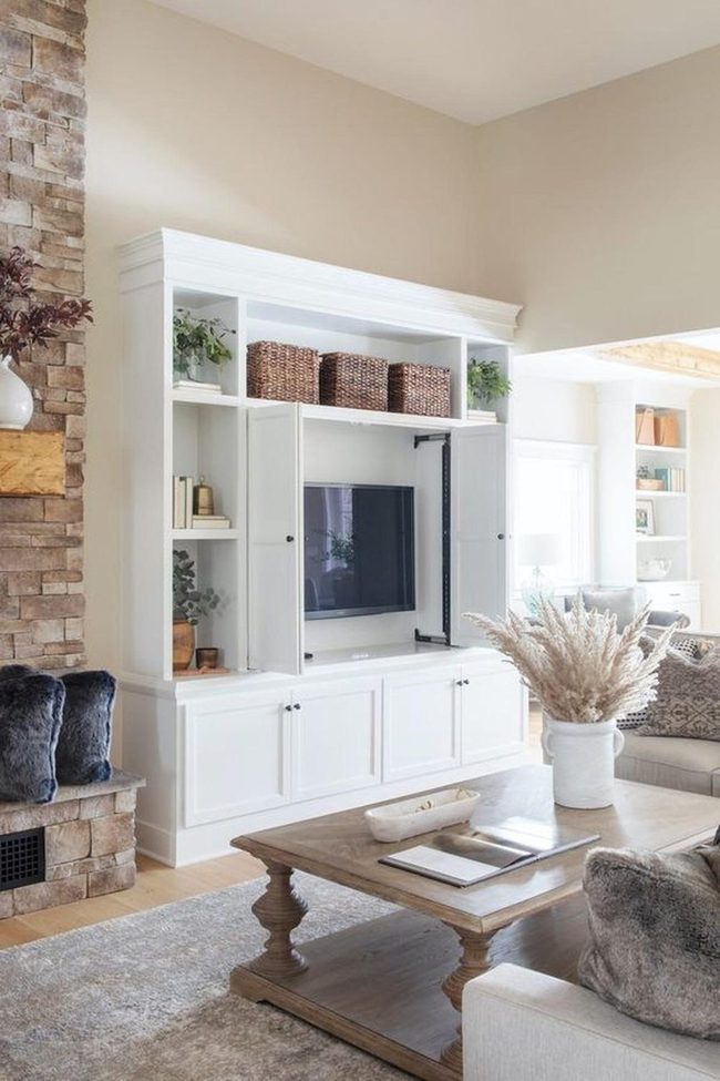 White Shelving With Stone Fireplace Warmth