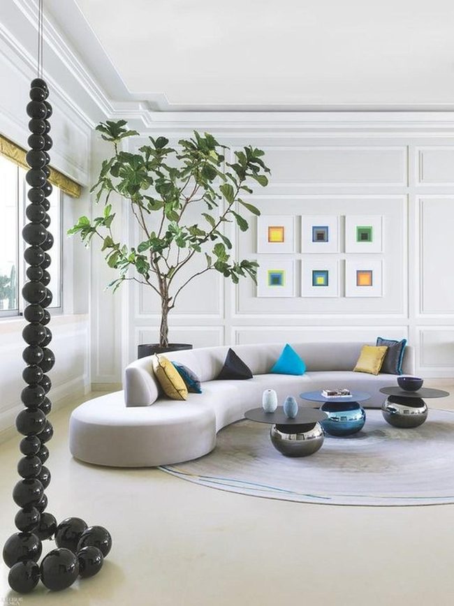 Pale Curved Sofa Meets Colorful Art