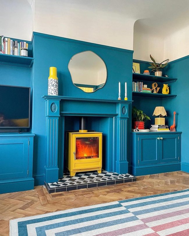 Round Mirror Brightens Blue Cabinetry